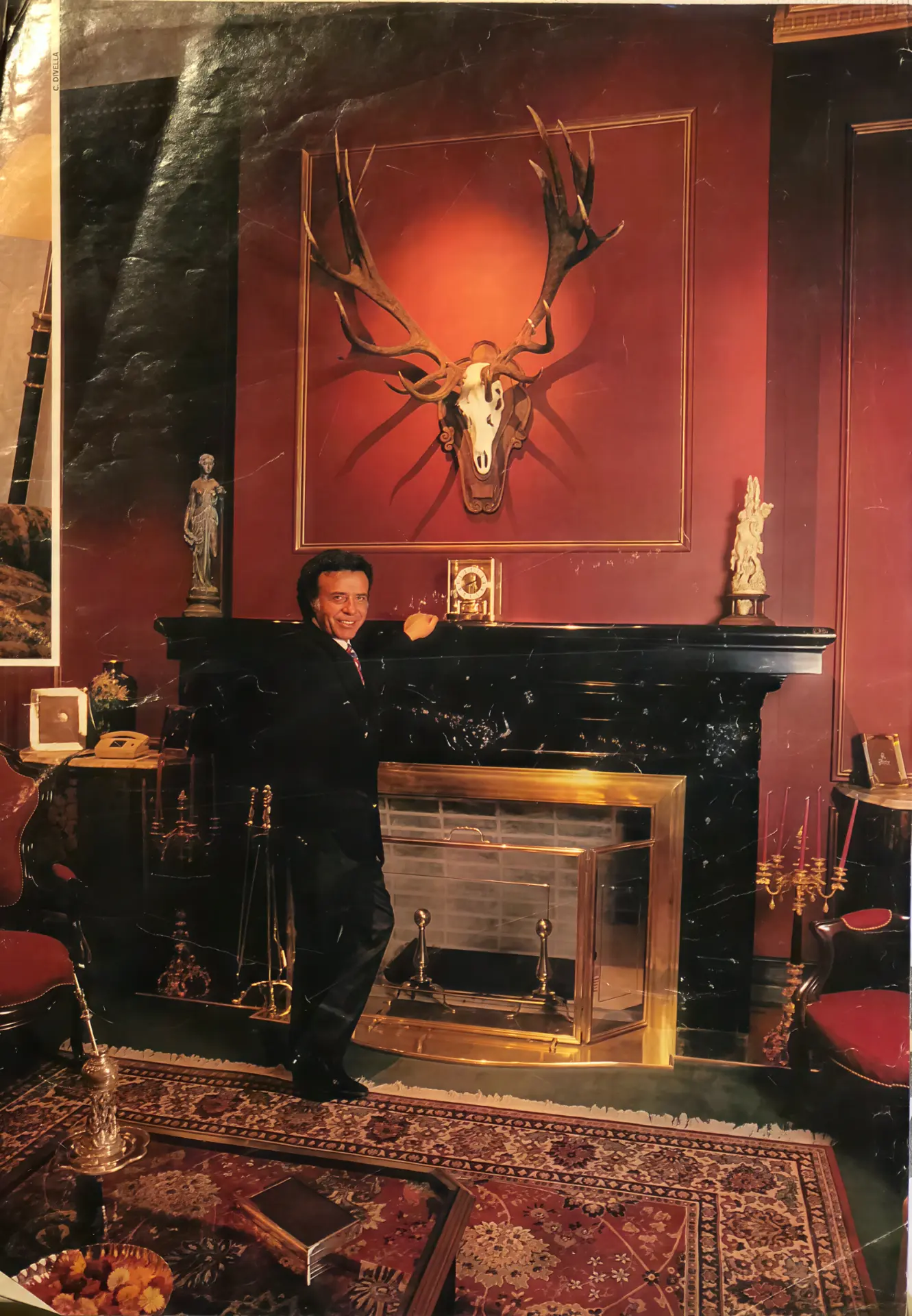 President Carlos Menem beside the fireplace at Parque Diana, beneath the mounted skull of the record red stag taken in 1995