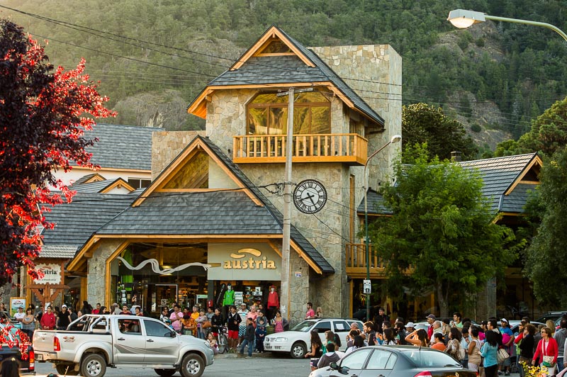 Main street of San Martín de los Andes with timber and stone Andean architecture and shoppers