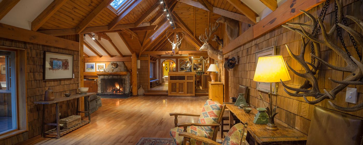Great room at Parque Diana lodge with open fire and trophy mounts
